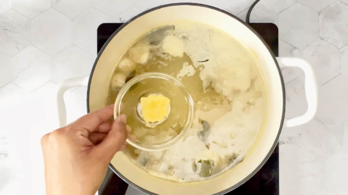 adding grated garlic to the boiling liquid