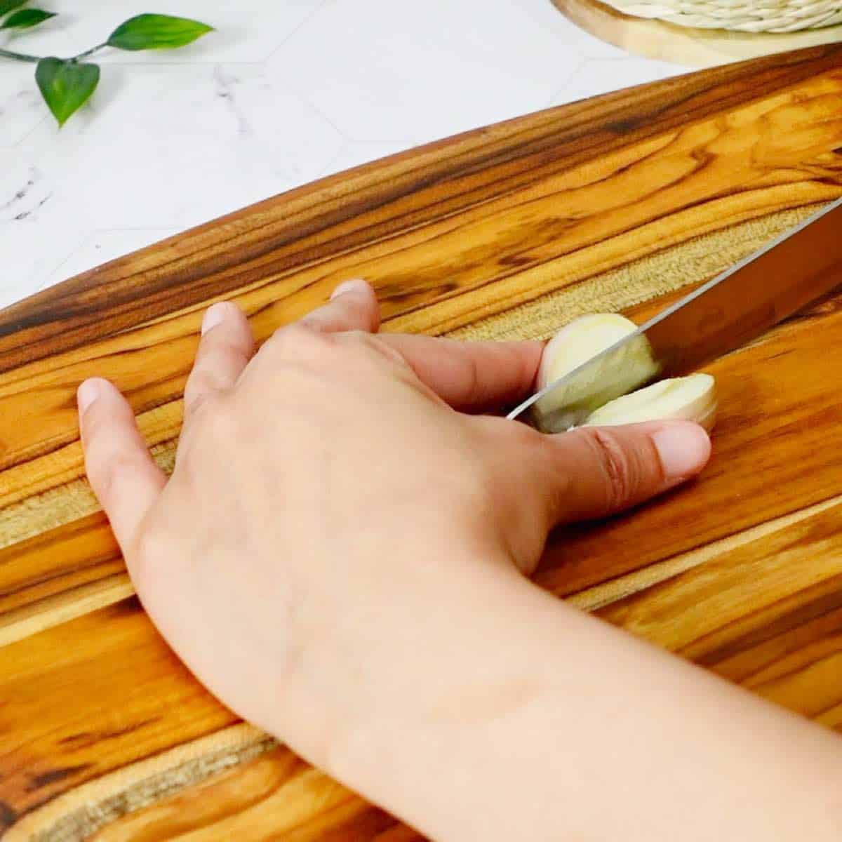 Cutting the garlic clove in half.