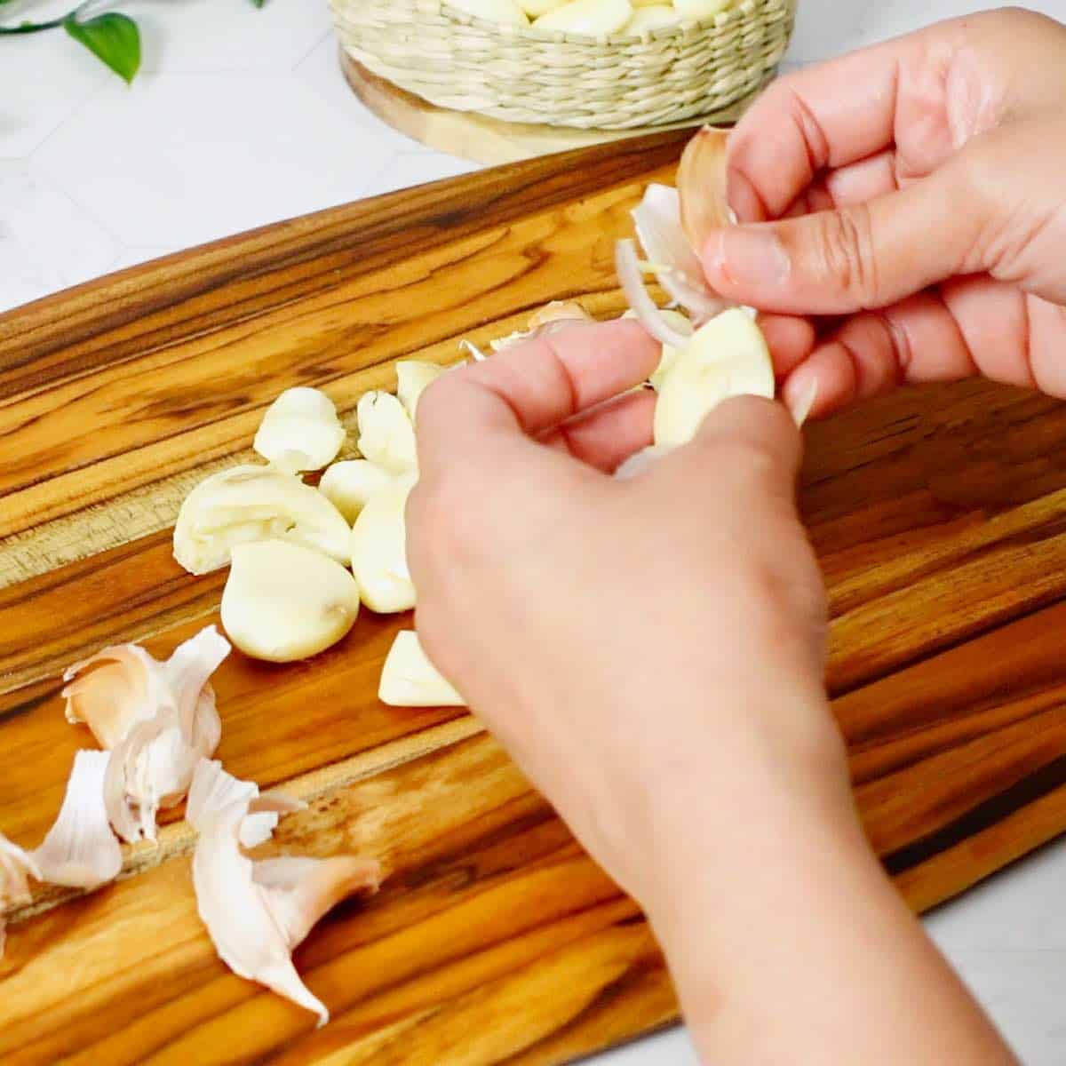Removing peel from the crushed garlic cloves.
