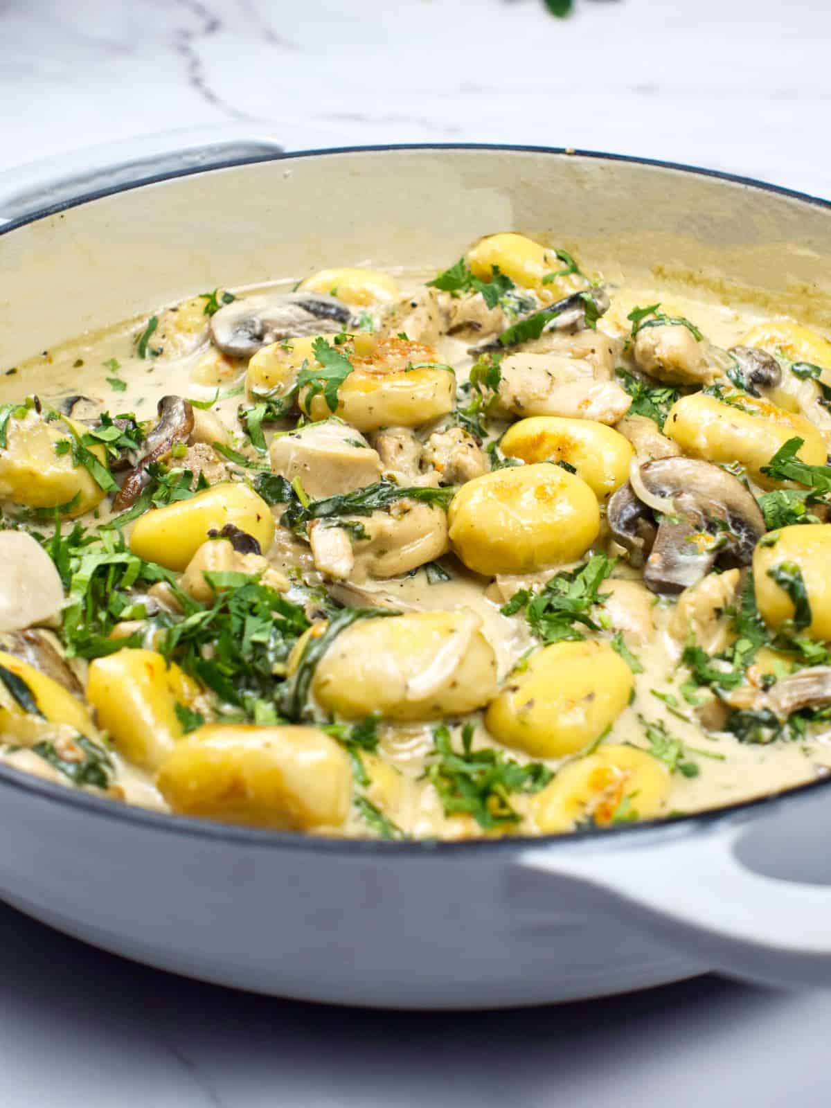 chicken and gnocchi with creamy truffle sauce in a skillet