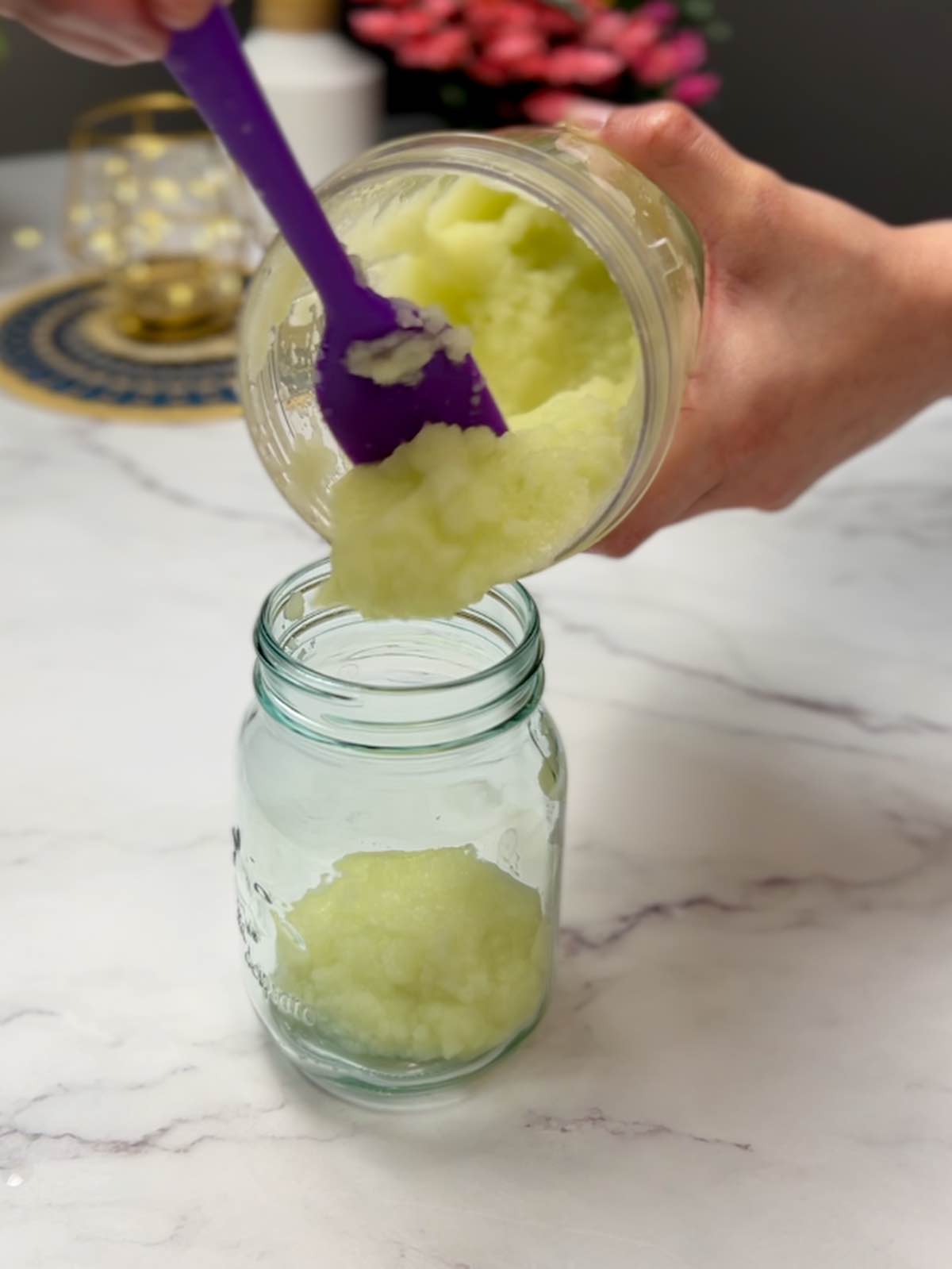 transferring papaya paste from a blender jar to a glass jar