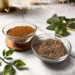 two bowls, one of ground cumin and the other of cumin seeds, placed side by side
