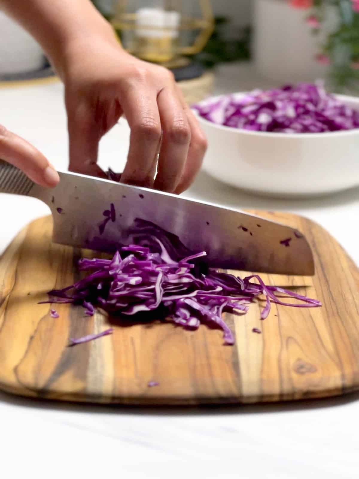 slicing purple cabbage using a claw grip