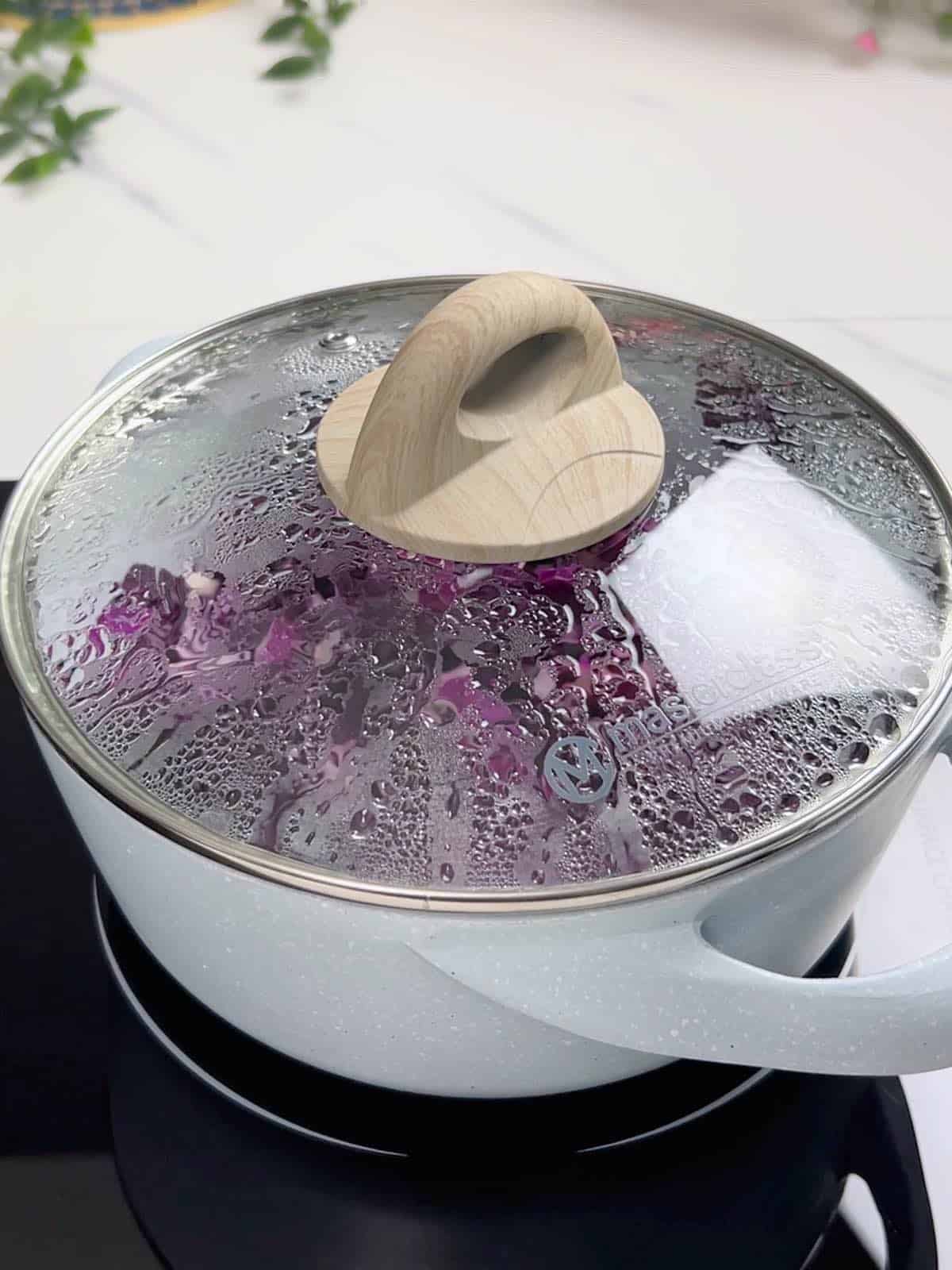 a pot with lid on and cabbage steaming inside
