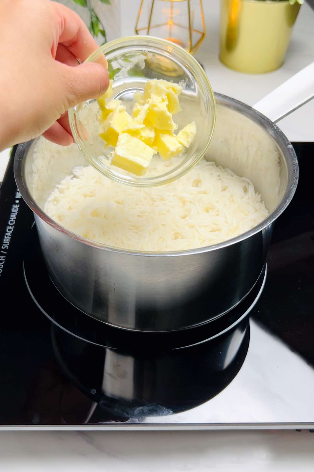 adding butter to half cooked basmati