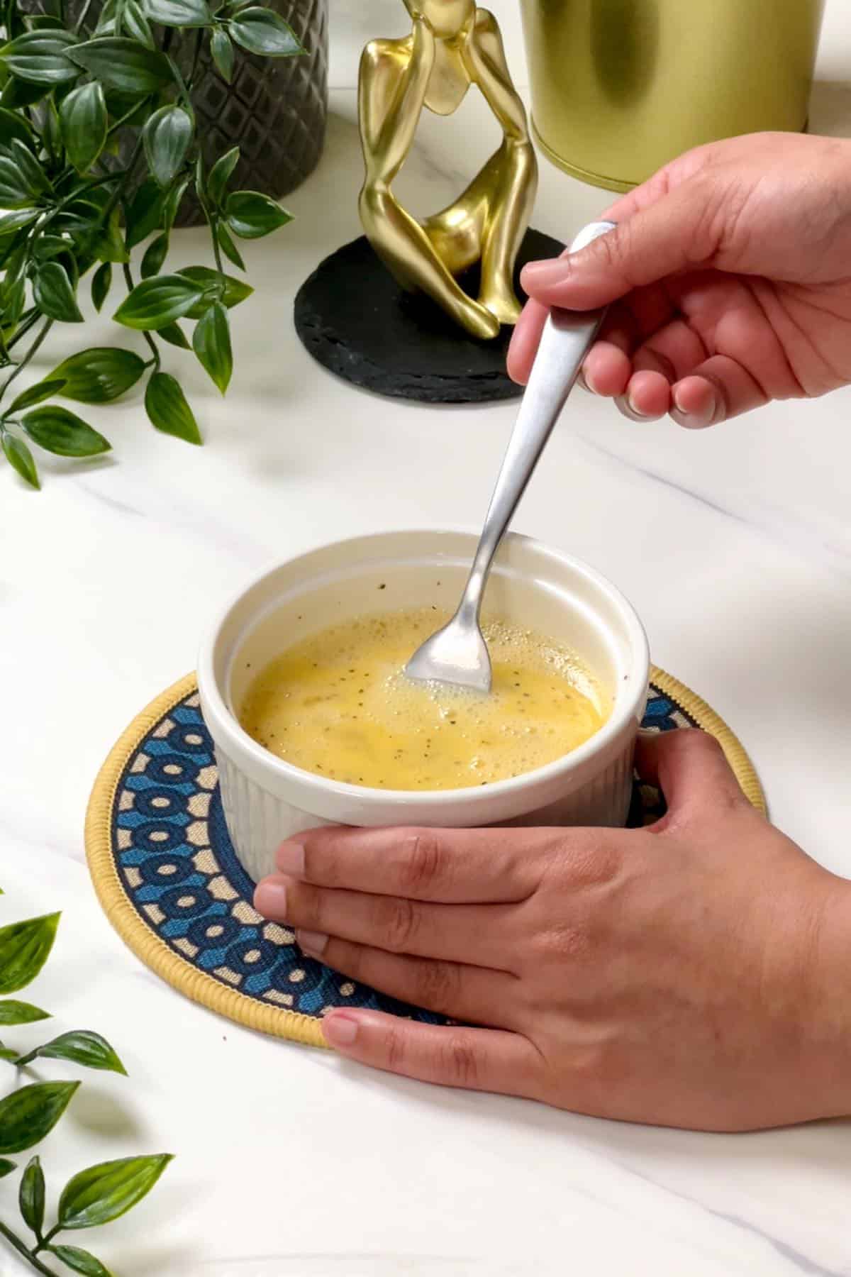 mixing eggs with salt, pepper and water