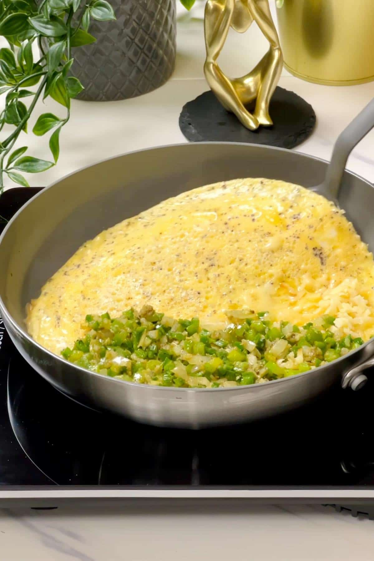 folding omelette in half to sandwich the jalapeno filling