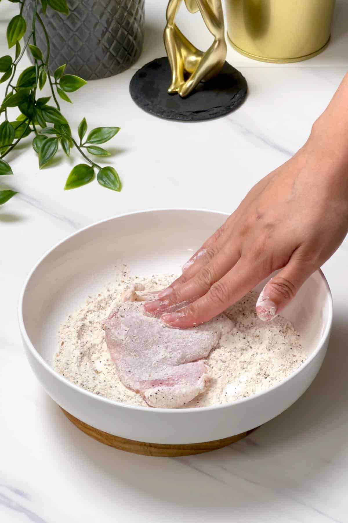 dredging chicken in the flour mixture