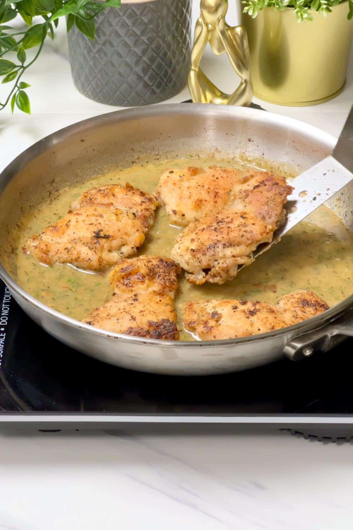 returning chicken to the pan containing lemon dill sauce