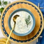 lemon dill sauce garnished with a sprig of dill