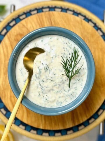 lemon dill sauce garnished with a sprig of dill