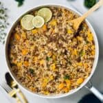 ground beef and rice skillet topped with parsley and lime slices