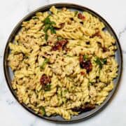 a plate of ground chicken pesto pasta
