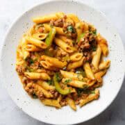 a plate containing ground beef and bell pepper pasta