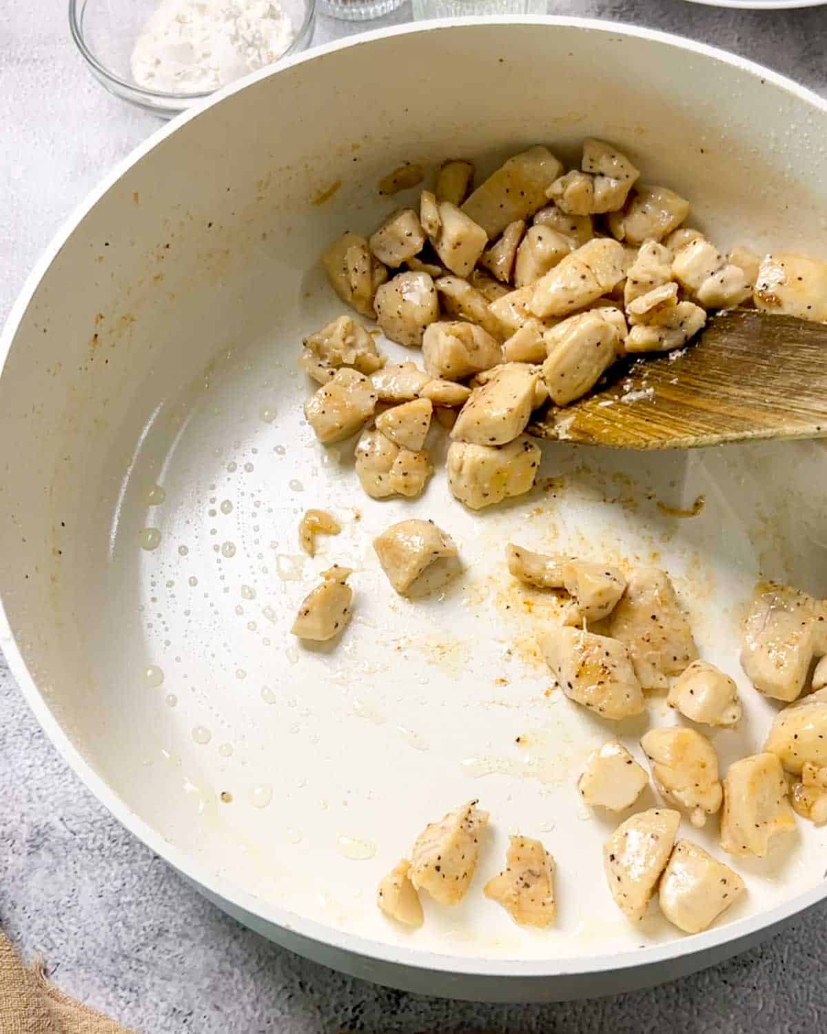 sautéing chicken pieces with seasonings