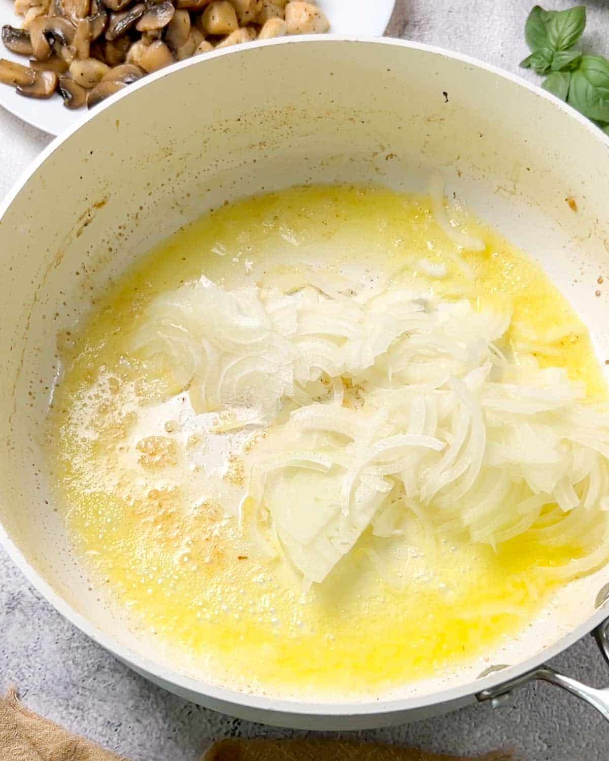 caramelizing sliced onion in a saucepan