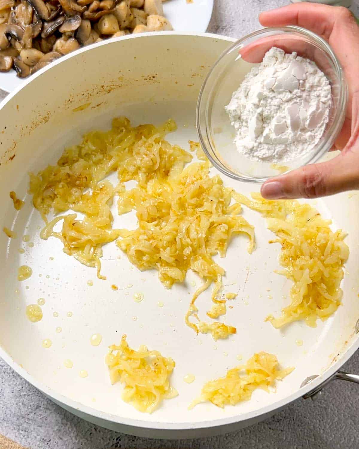 adding flour to caramelized onion