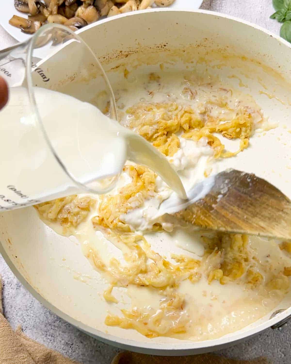 adding milk to the flour mixture to make roux