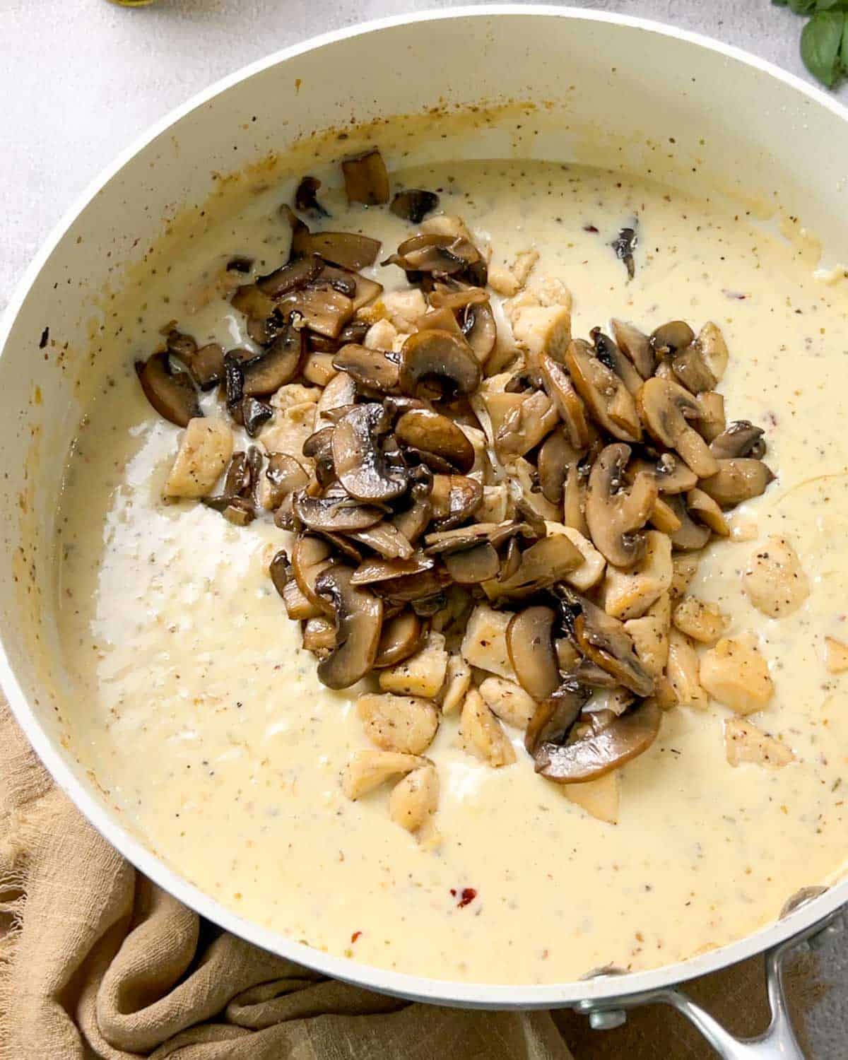adding back cooked chicken and mushrooms