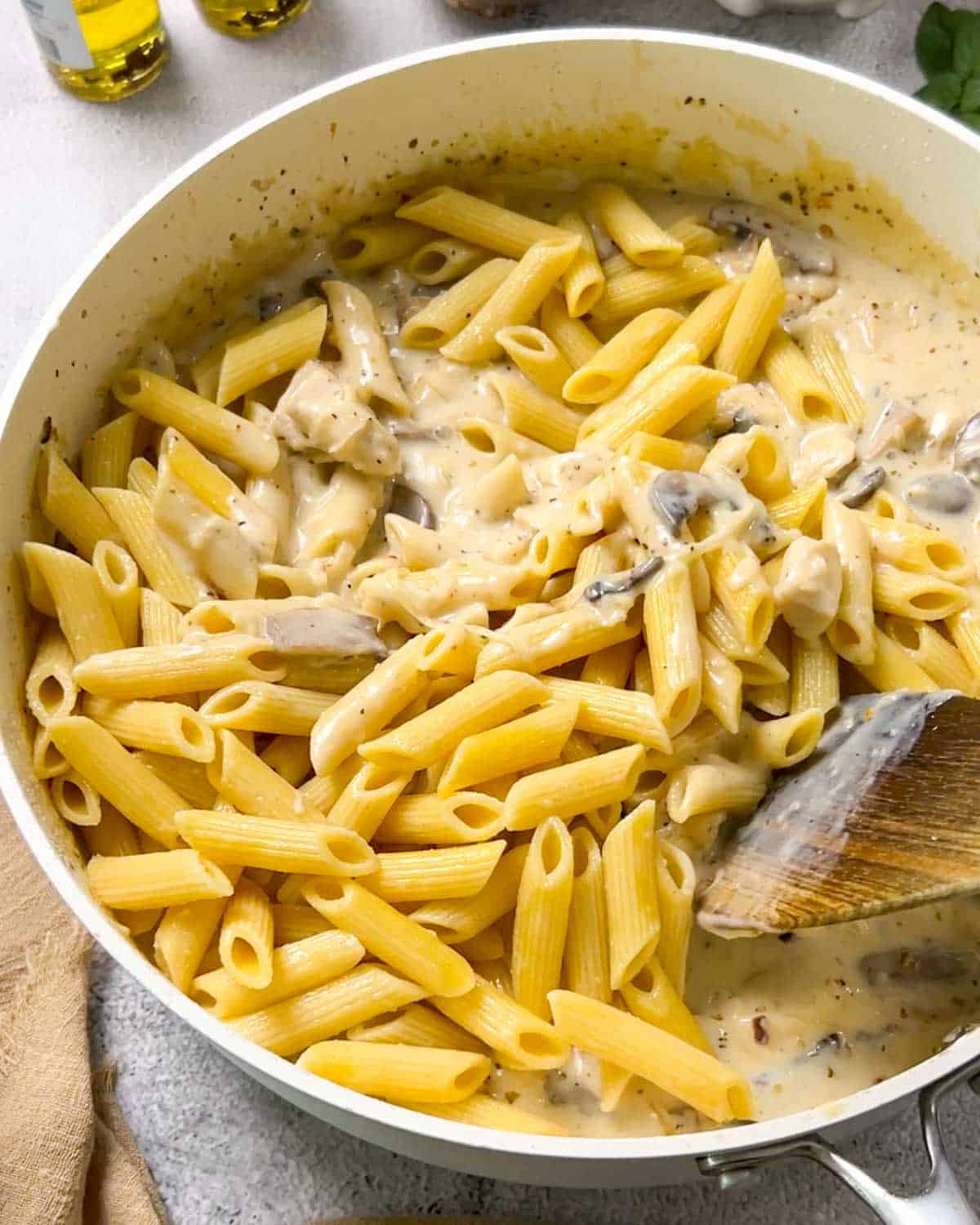 adding cooked pasta and mixing everything together