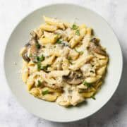 Chicken and mushroom pasta in a white bowl.