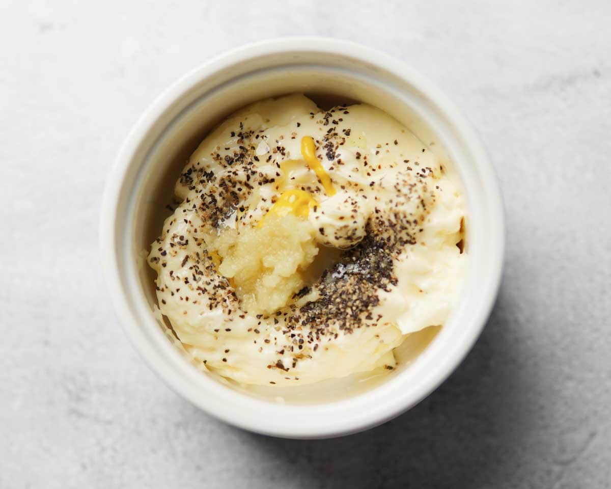 a bowl containing mayo, truffle oil, and other aioli ingredients