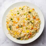 mixed vegetable rice with peas, carrots, corn and beans on a plate