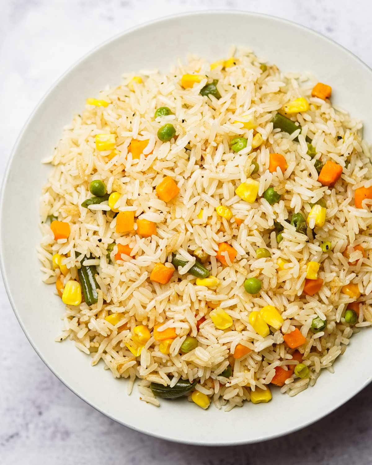 colorful mixed vegetable rice with peas, carrots, corn and beans