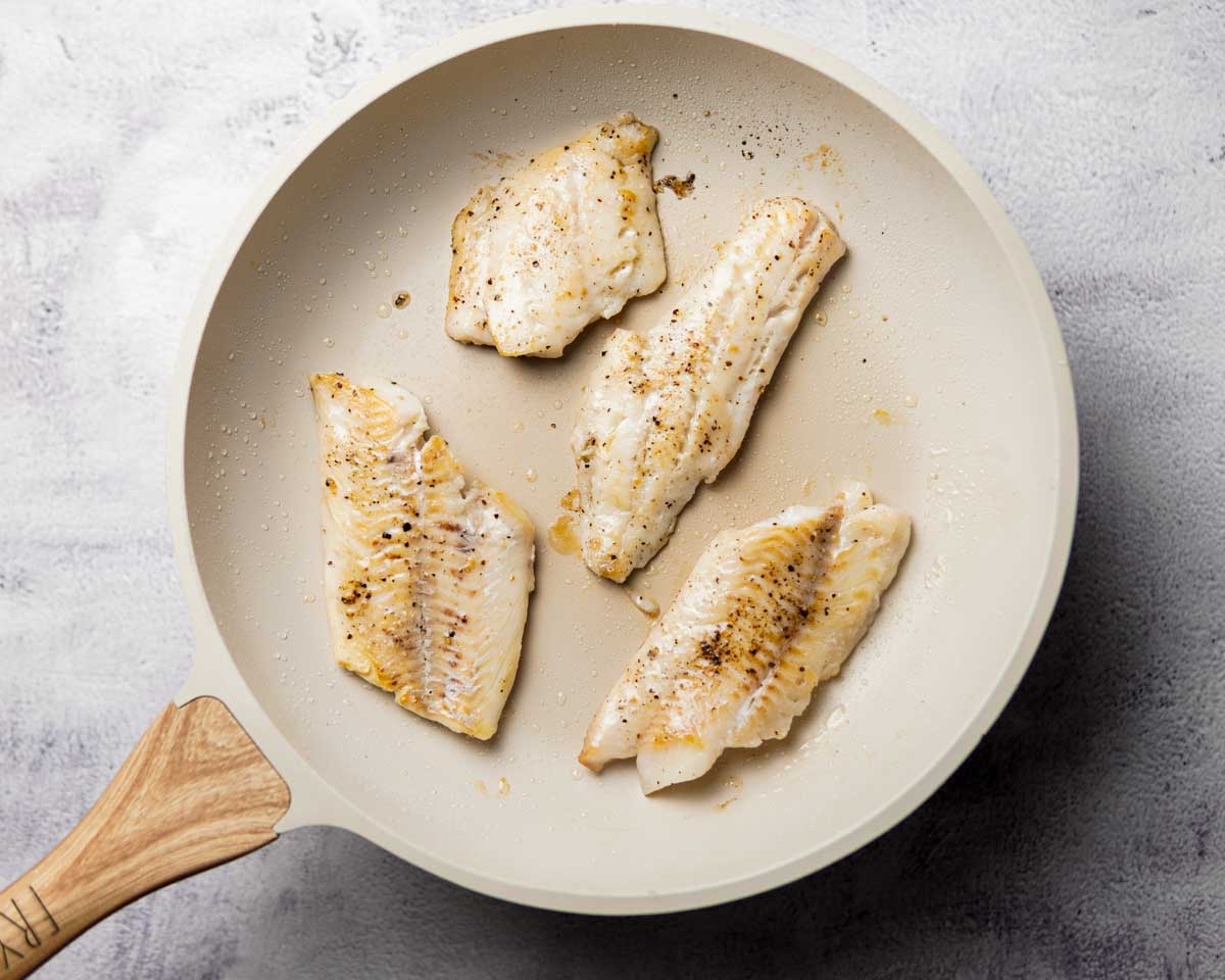 seasoned seared haddock in a pan