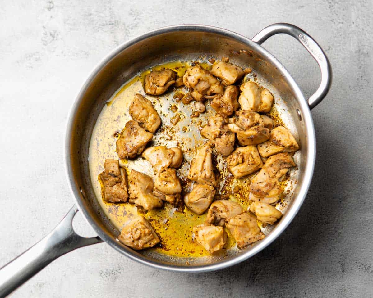seasoned and cooked chicken pieces in a skillet