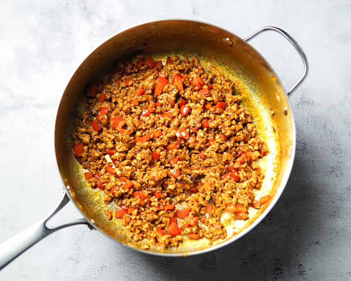 browned and seasoned ground chicken in a skillet