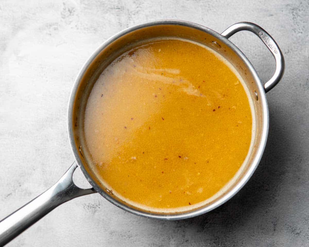 a skillet containing seasoned liquid base