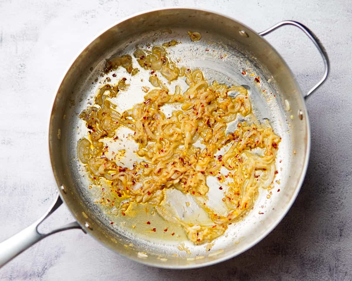 sautéed onion, garlic and chili flakes in a pan