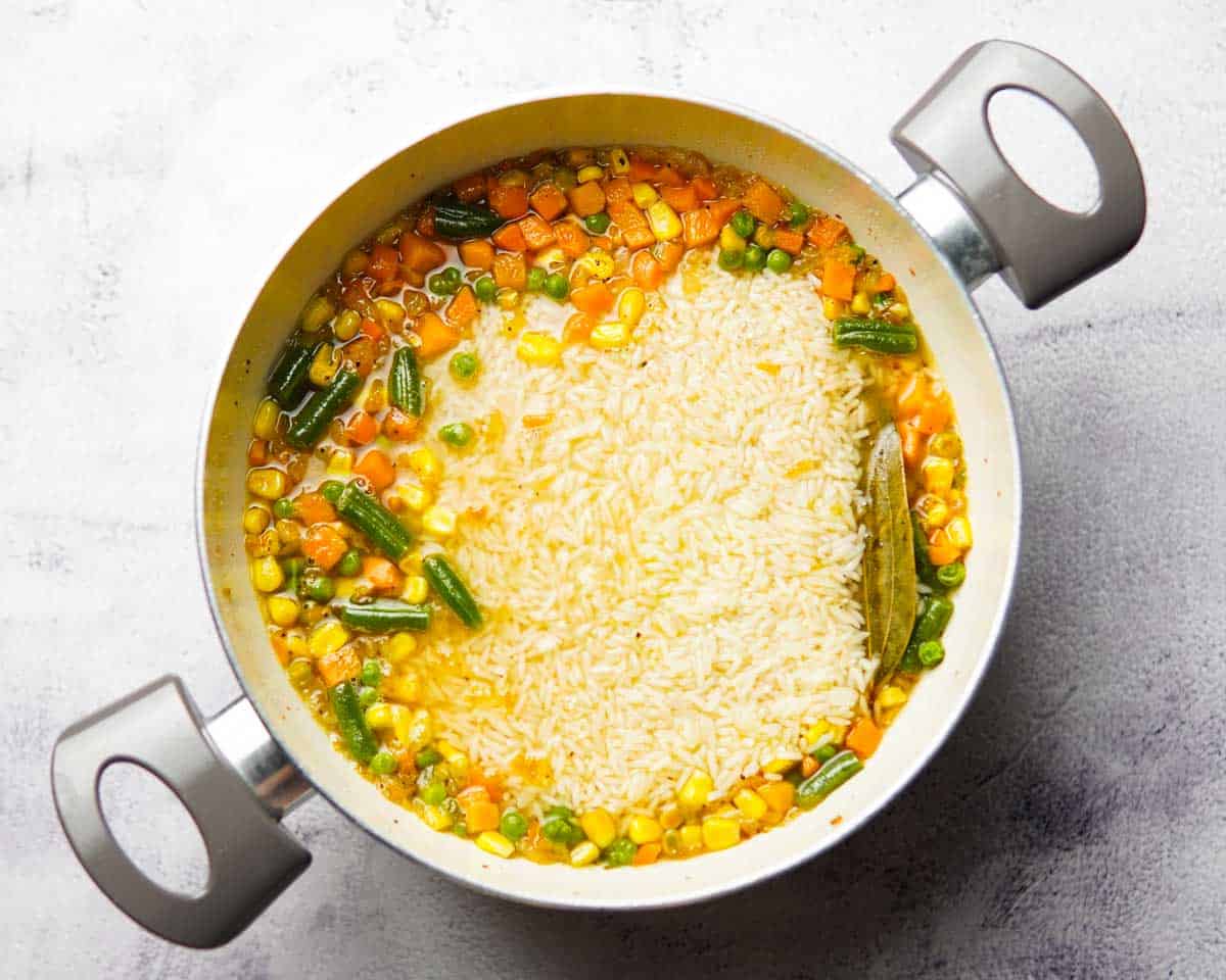 rice, mixed veggies, and water in a saucepan