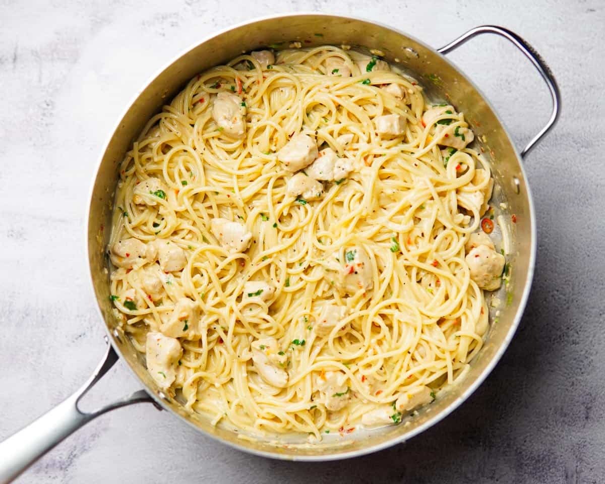 chili lime chicken pasta in a stainless steel pan, garnished with cilantro