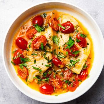 stove top haddock in tomato sauce served on a plate