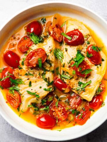 stove top haddock in tomato sauce served on a plate