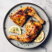 baked lemon pepper chicken leg quarters on a plate