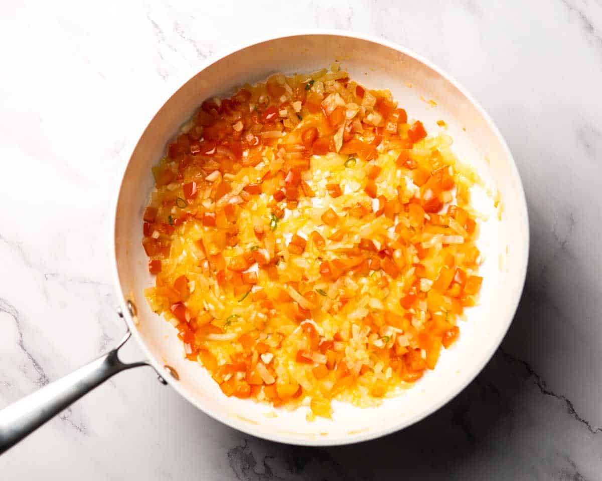 softened onion, bell peppers, garlic in a skillet
