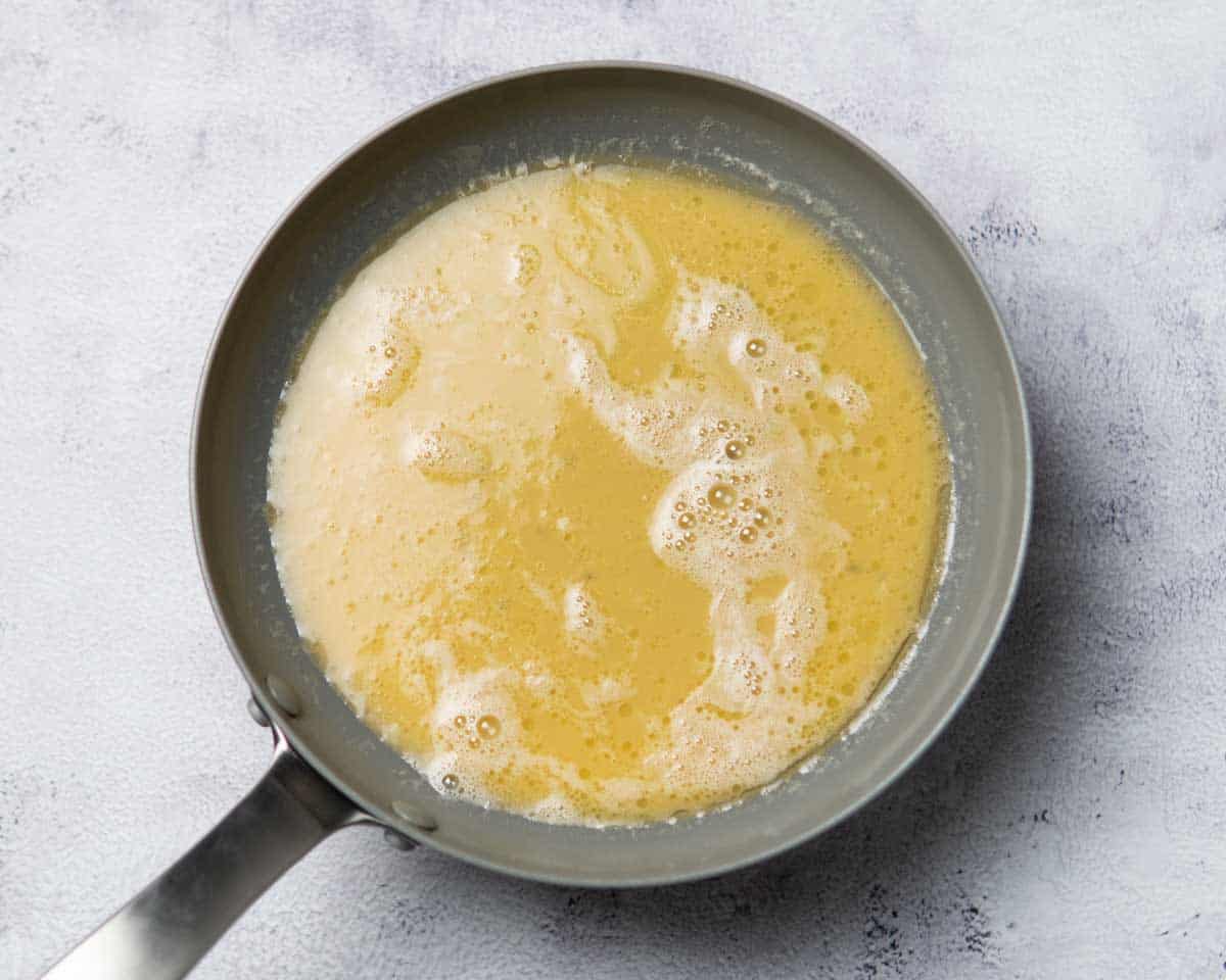 whisked eggs cooking in a pan