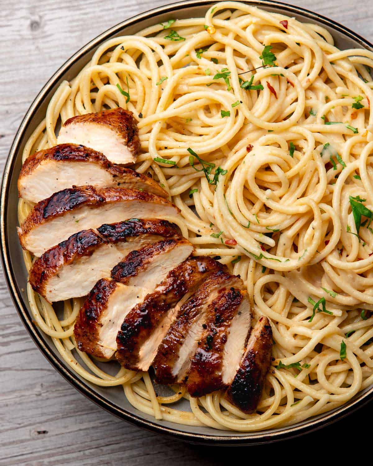 a plate containing jerk chicken pasta
