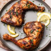 baked chicken leg quarters on a plate