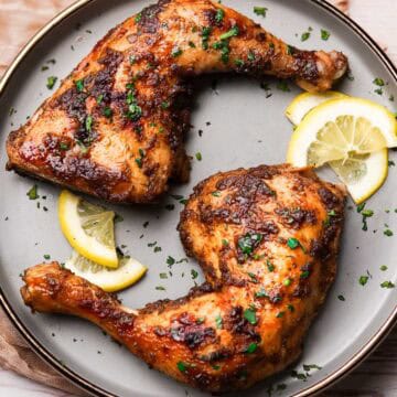 baked chicken leg quarters on a plate