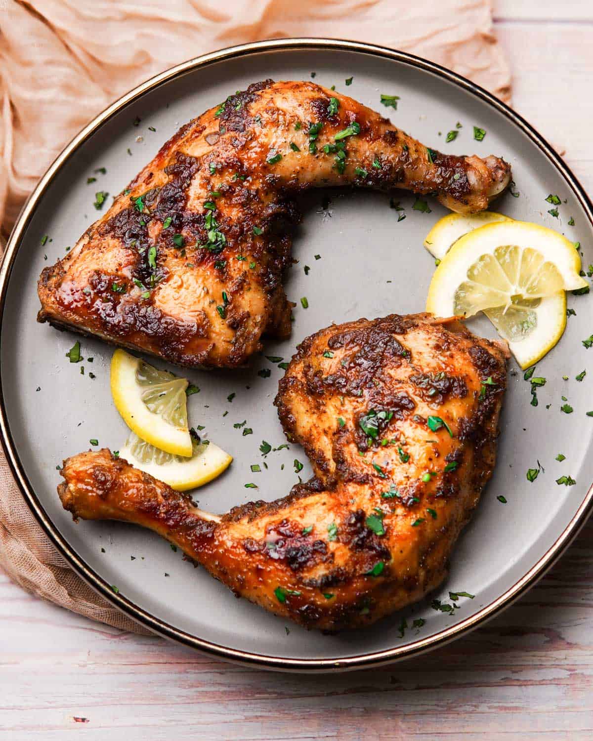 baked chicken leg quarters served on a plate